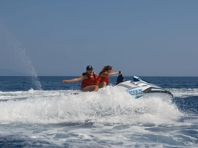 Couple catching air on a jet ski