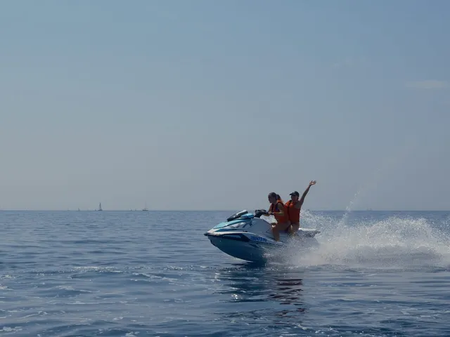 Distant couple in action on the open sea