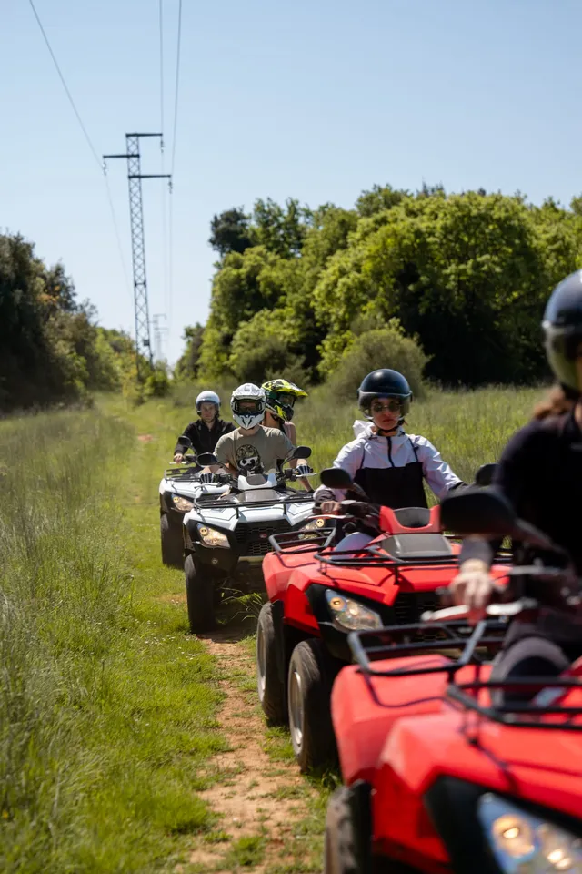 Line of quads waiting on a trail