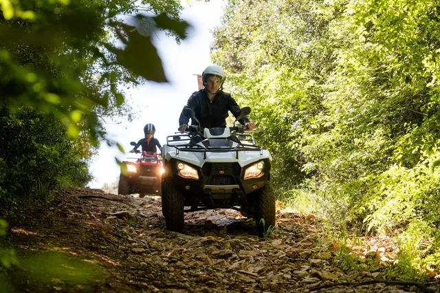 White quad on a rocky woodland trail