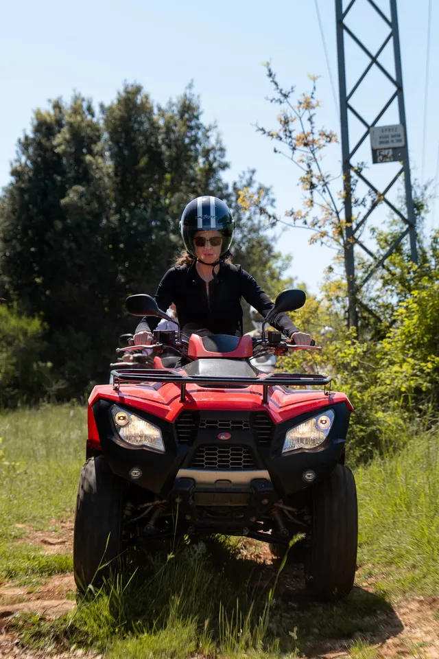 Rider on a quad beside a power-line clearing