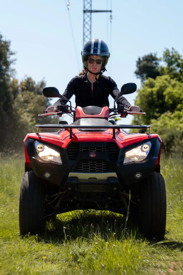 Quad rider portrait in a sunlit meadow